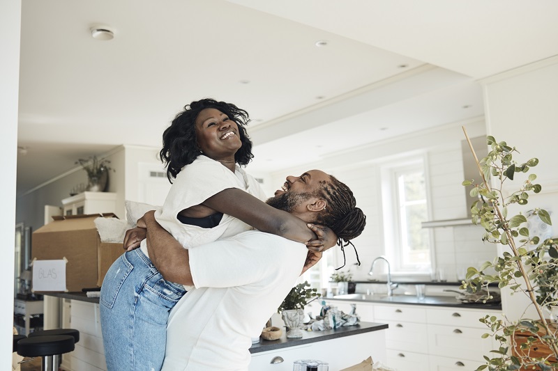 Young couple hugging in a sunny kitchen