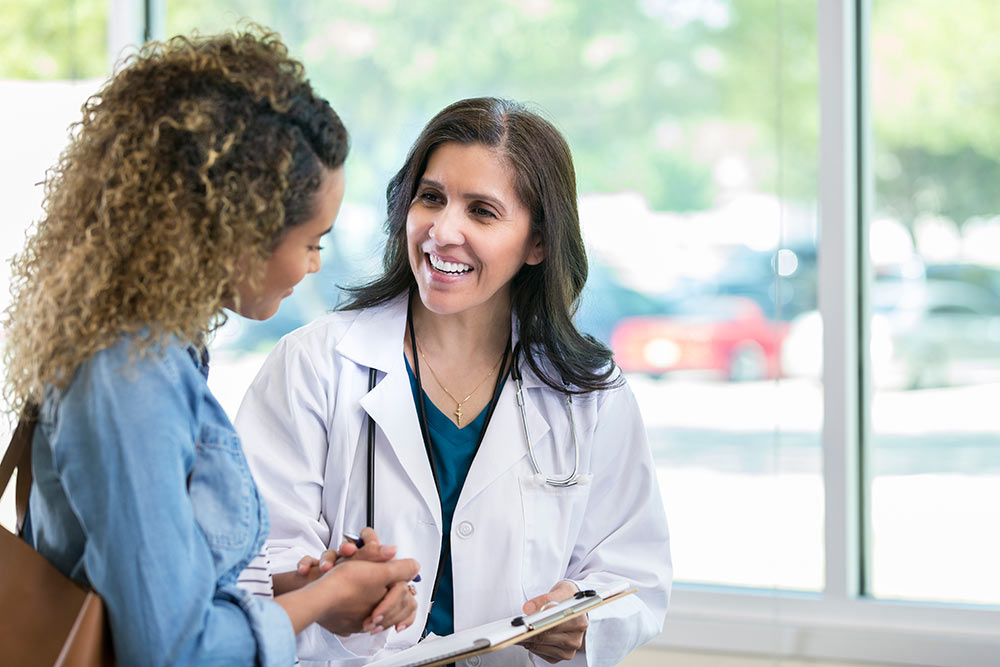 958886668. A female doctor reviewing patient's records.