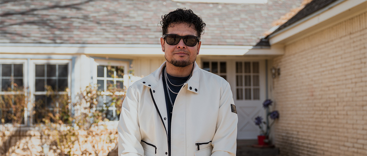 Juan Tejada, a member of Blue Cross and Blue Shield of New Mexico, poses outside the Albuquerque home where he lives